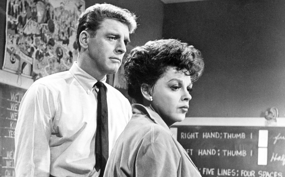 Actor Burt Lancaster stands next to Judy Garland, though they don't speak.