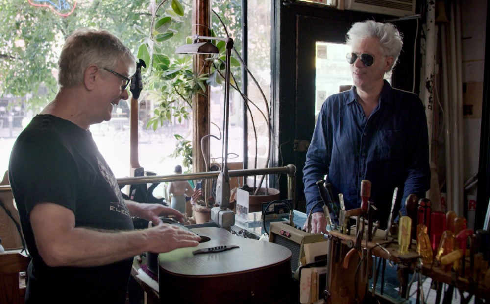 Musician Jim Jarmusch walks into Carmine Street Guitars; store owner Rick Kelly greets him.