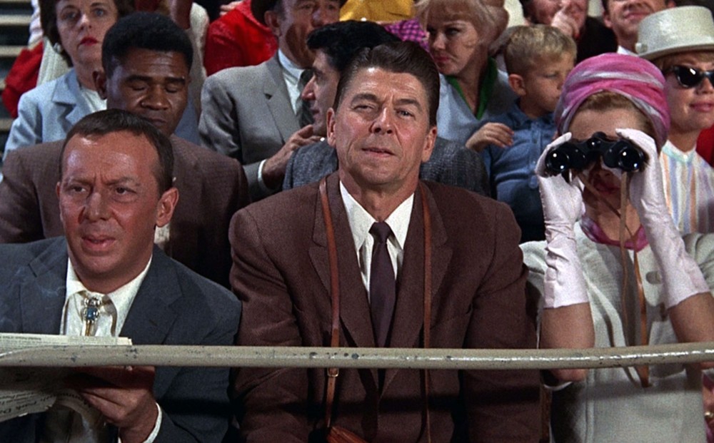 Actor Ronald Reagan sits in the audience at the race track.