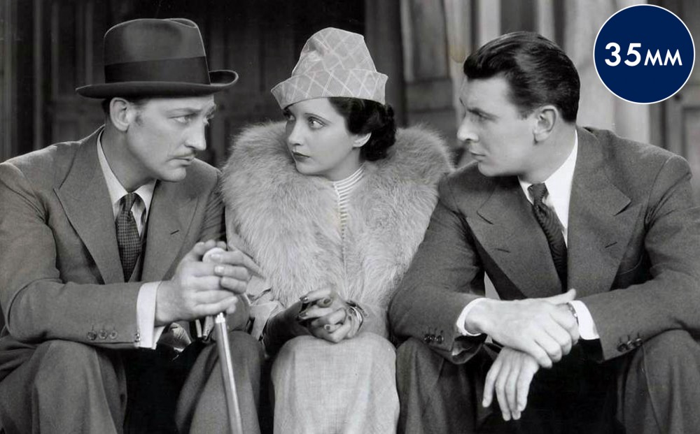 Actors George Brent, Kay Francis, and Warren William sit together.