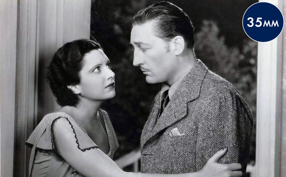 Actor Kay Francis holds Warren Williams' arms.