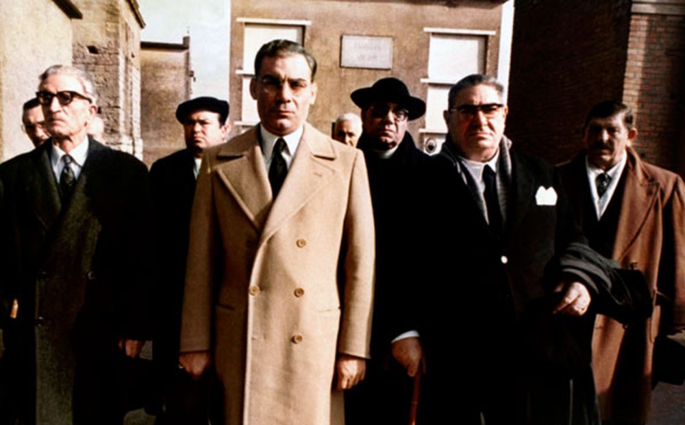 Actor Gian Maria Volontè stands with a group of seven men.