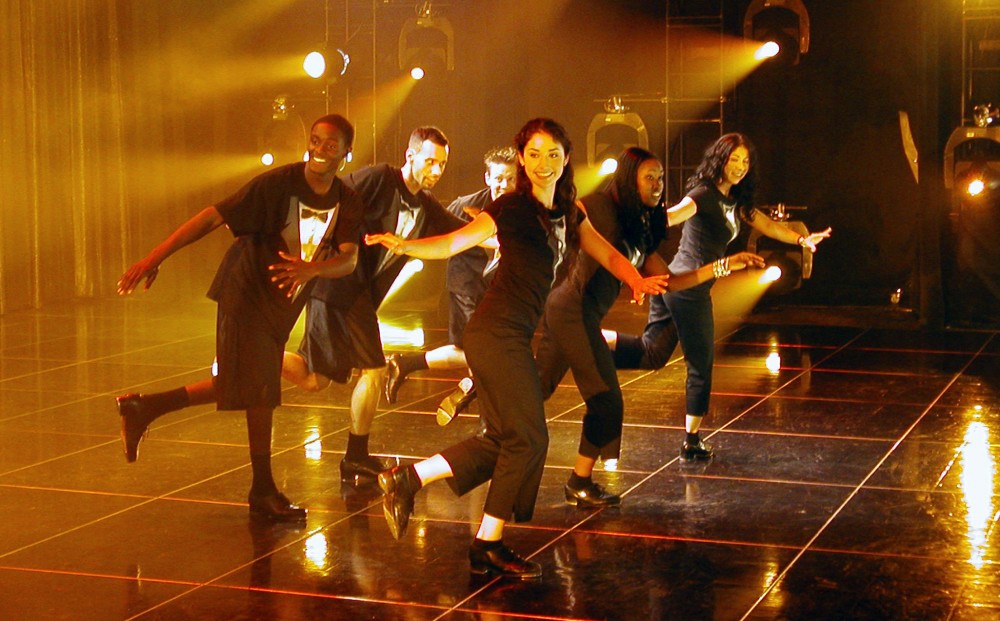 From TAP HEAT - three men and three women tap dance on a stage.