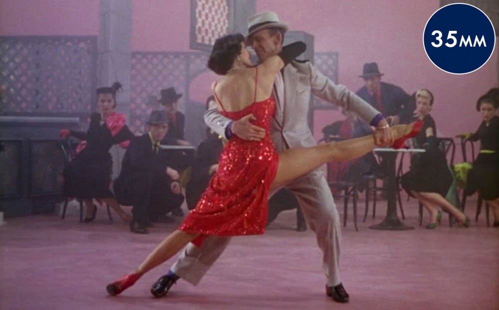 Actors Cyd Charisse and Fred Astaire dance together on the set in the film.