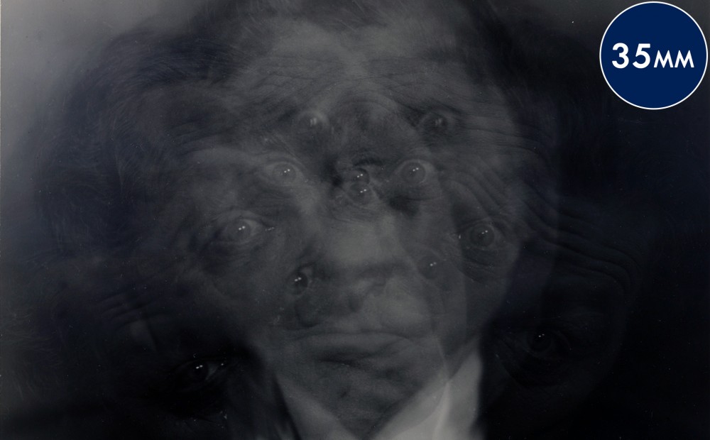 An image of a man's face that is blurred so that he appears to have many eyes.