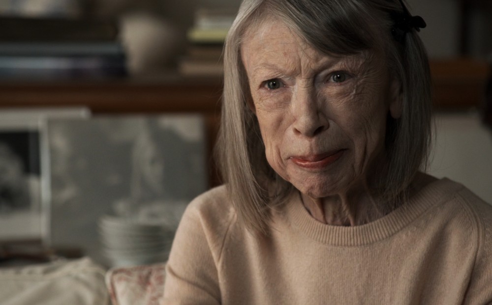 Close-up on Joan Didion (an elderly woman), speaking to the camera.
