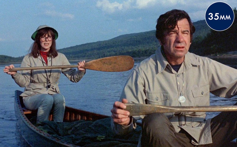 Actors Walter Matthau and Elaine May sitting in a canoe.