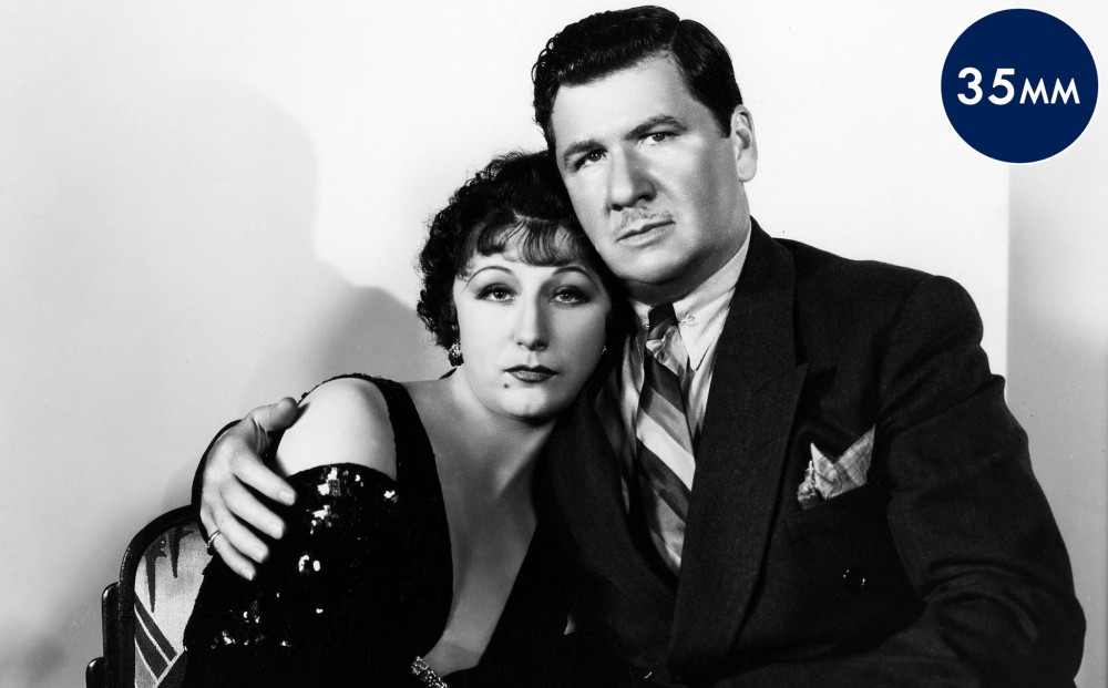 Actor George Bancroft has his arm around actor Judith Anderson.