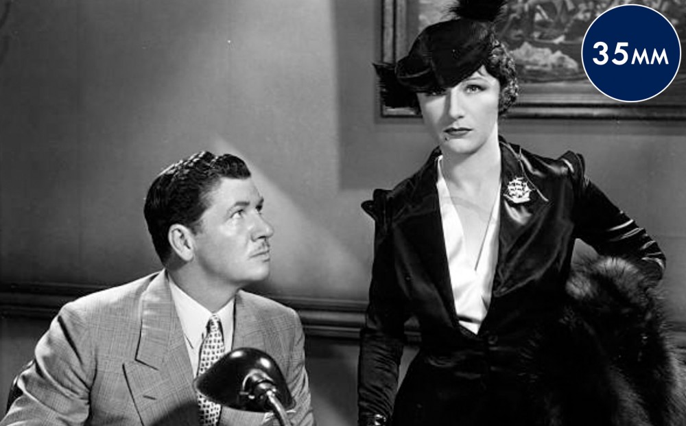 Actor George Bancroft looks intently at Judith Anderson.