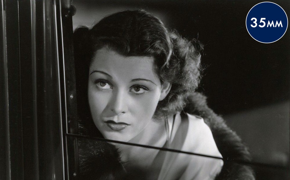 Actor Frances Dee peers up through a window.