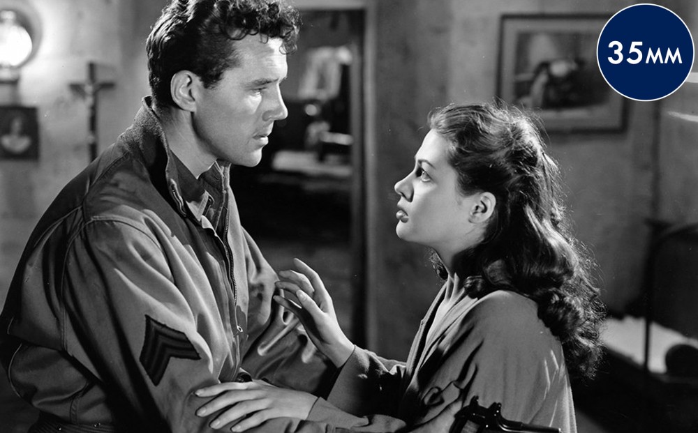 Actor Burt Lancaster and a woman holds each other's arms.