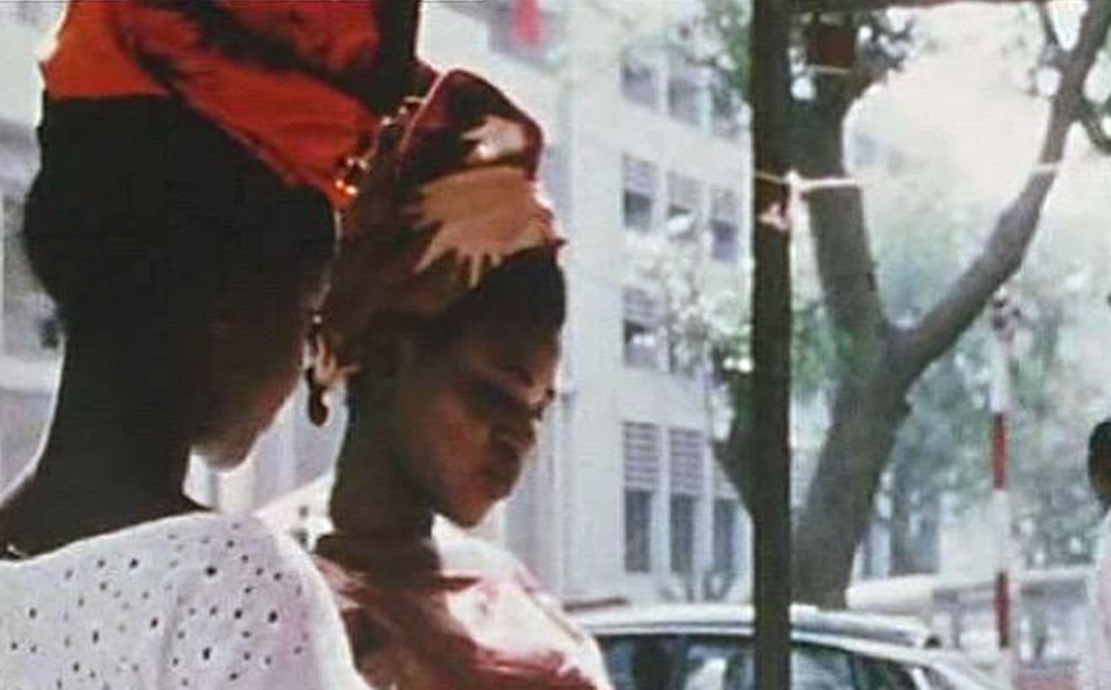 From Contras’ City: two women wearing head scarves stand on the street. 