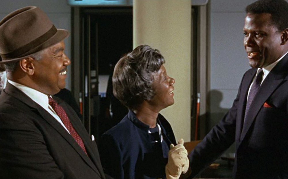 Actor Sidney Poitier stands with the two actors who play his parents.