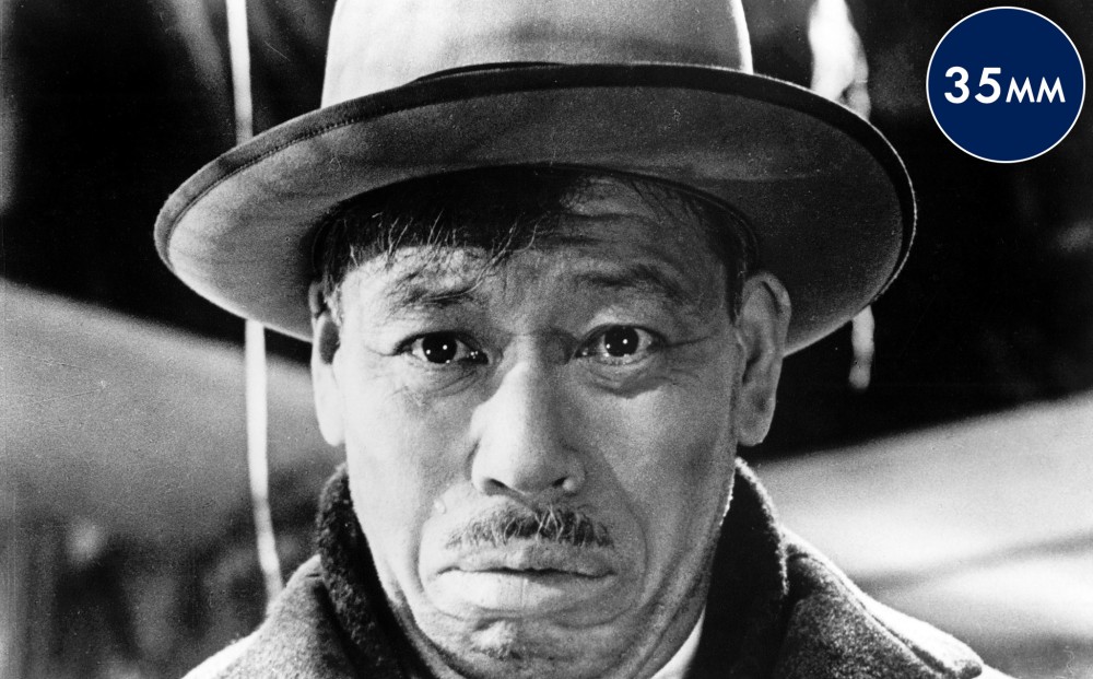 Close-up on the face of a forlorn Takashi Shimura.