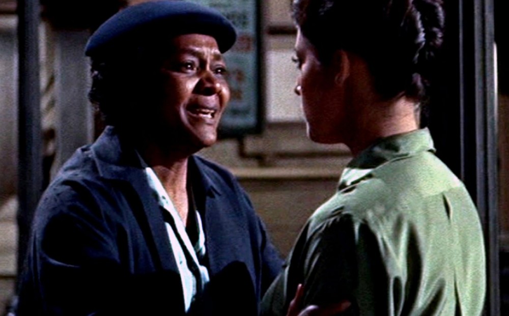 Actor Juanita Moore faces another woman and looks upset.