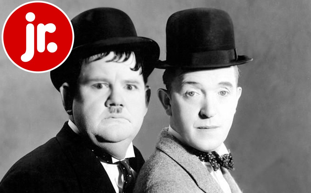 Close up on Laurel and Hardy's faces, standing side-by-side.