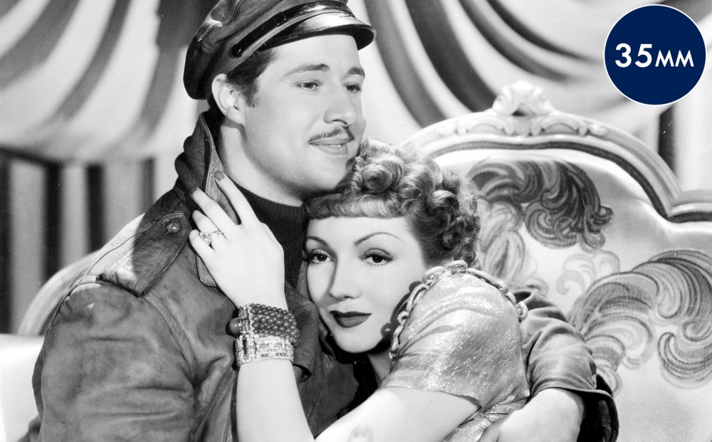 Actors Don Ameche and Claudette Colbert embrace each other; her head rests on her chest.