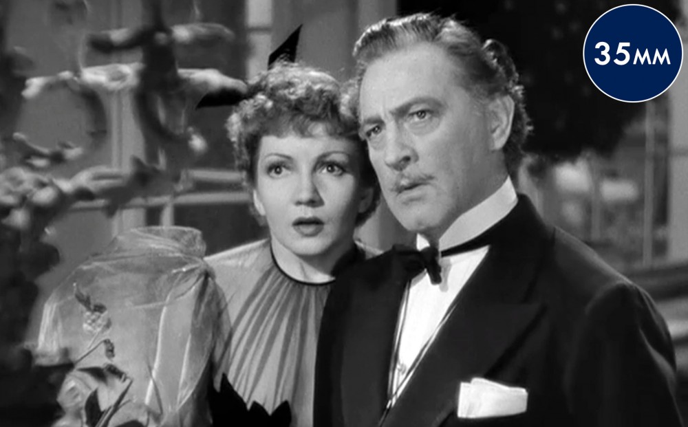 Actors Mary Astor and John Barrymore look in the same direction, both seeming somewhat shocked.