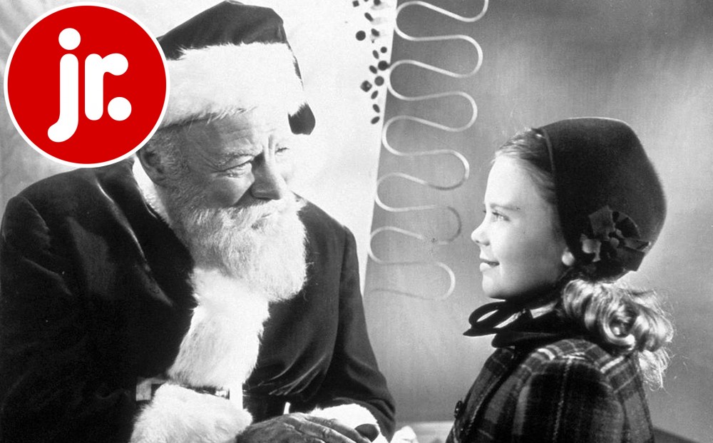 Actor Natalie Wood smiles at Edmund Gwenn, dressed as Santa Claus.