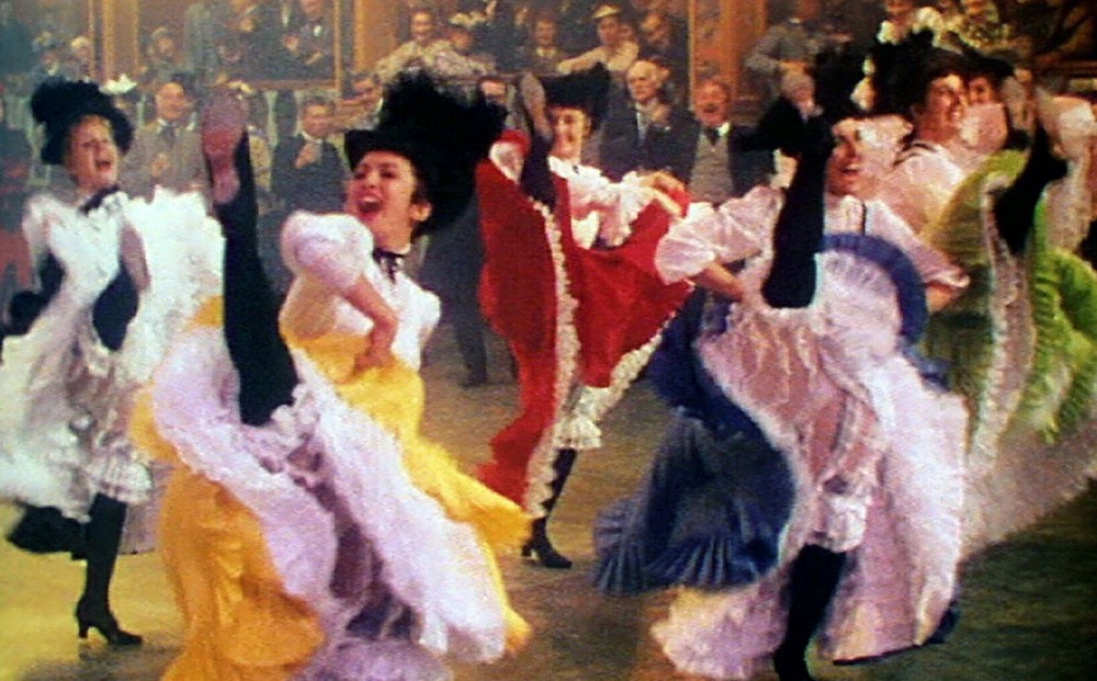 A group of dancers at the Moulin Rouge do the can-can.