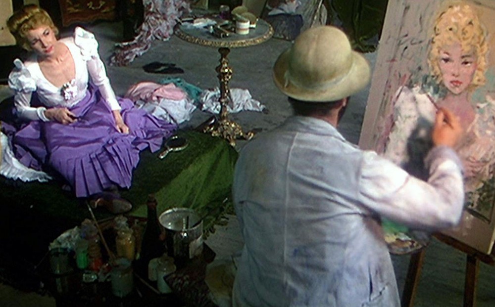 Actor José Ferrer as Henri Toulouse-Lautrec paints of a portrait of a seated Zsa Zsa Gabor.