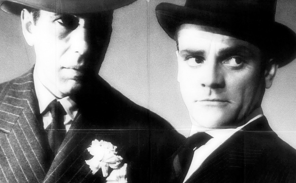 A black and white image of two men in suits and hats.