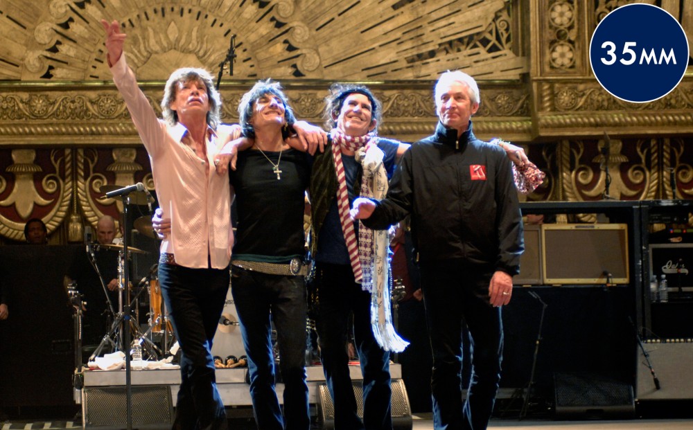 The four main members of The Rolling Stones take a bow at the front of the stage.