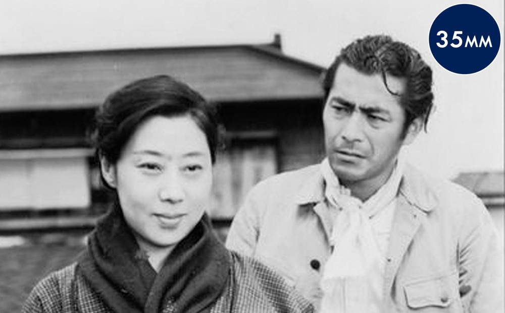 Actor Toshirô Mifune looks at Isuzu Yamada.