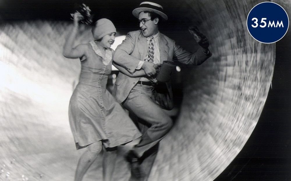 Actors Harold Lloyd and Ann Christy run together.