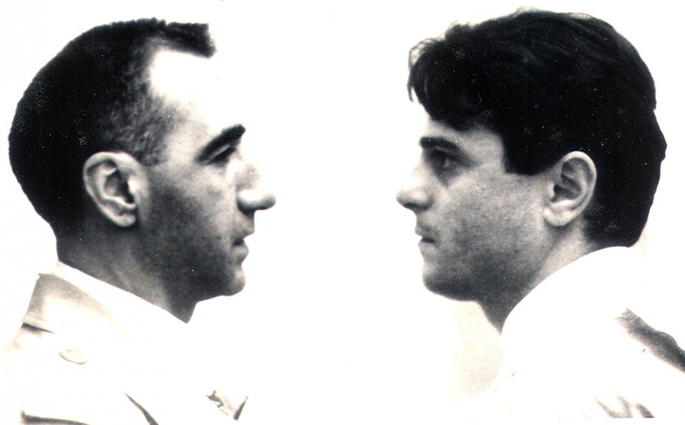 Black and white close-up of two men facing each other.