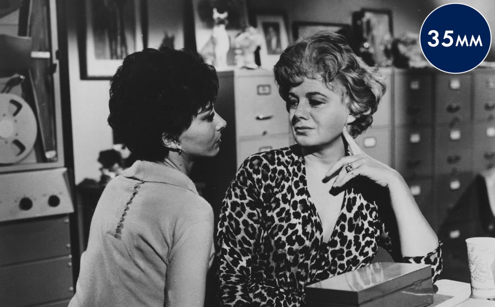 Actors Shelley Winters and Lee Grant sit close to one another.