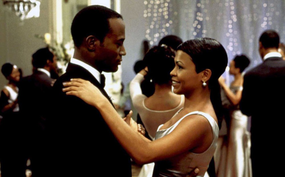Actor Taye Diggs dances with a woman at a wedding.