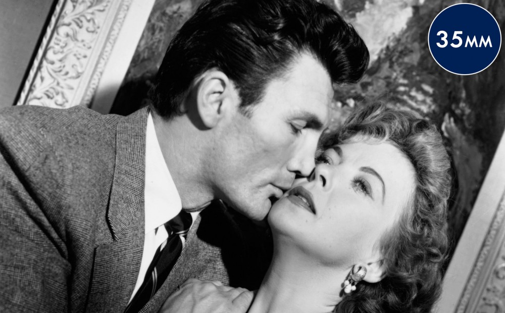 Actor Jack Palance is about to kiss Ida Lupino.