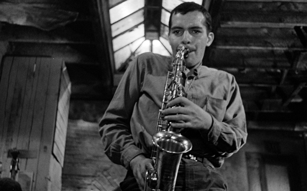 A man plays a saxophone.