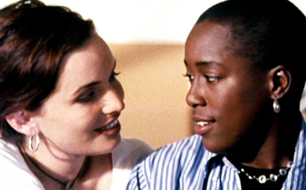Close-up on actors Cheryl Dunye and Guinevere Turner, who look at each other and smile.