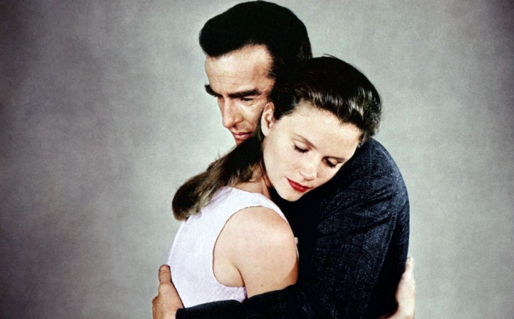 Actors Lee Remick and Montgomery Clift hug each other.