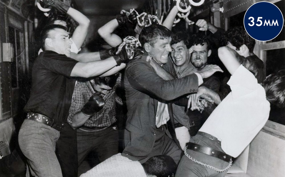 A group of men brawl.